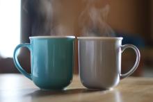 Two cups of steaming coffee